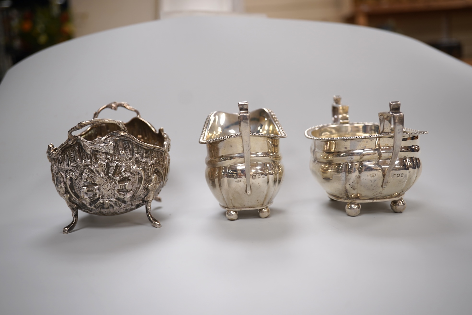 A George V silver two handled sugar bowl and matching cream jug, Z Barraclough & Sons, London, 1918, together with a late 19th century German Hanau silver sugar bowl, 10.5oz.